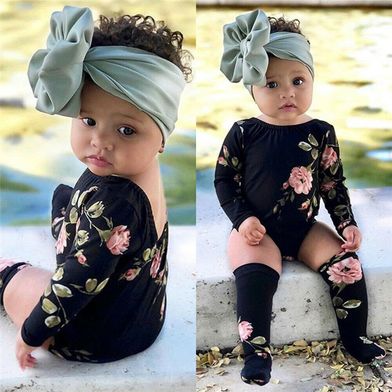 Neviah's vintage black floral onsie with matching socks